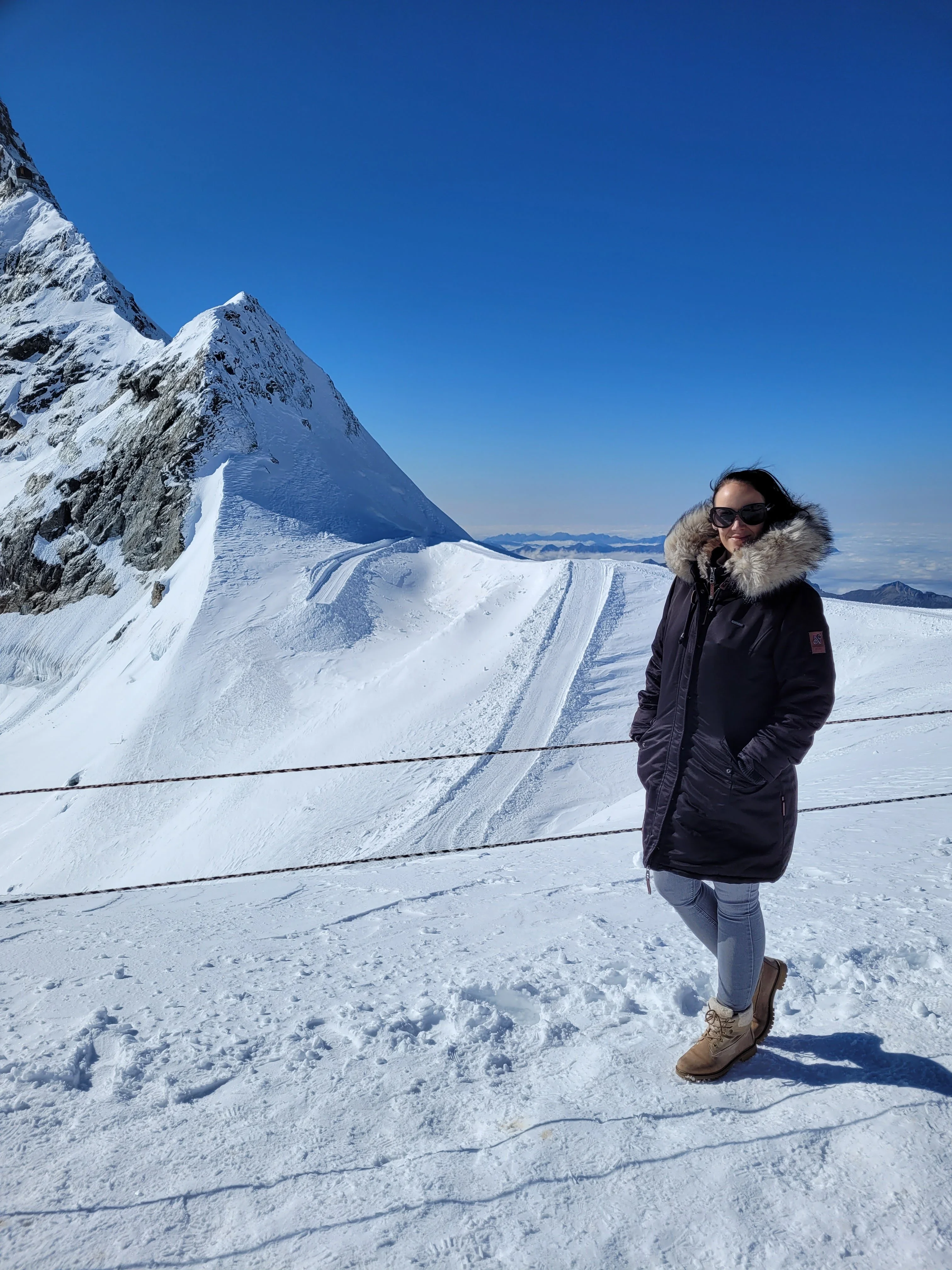 Sandra Walenta overlooking snow-covered Alpine peaks