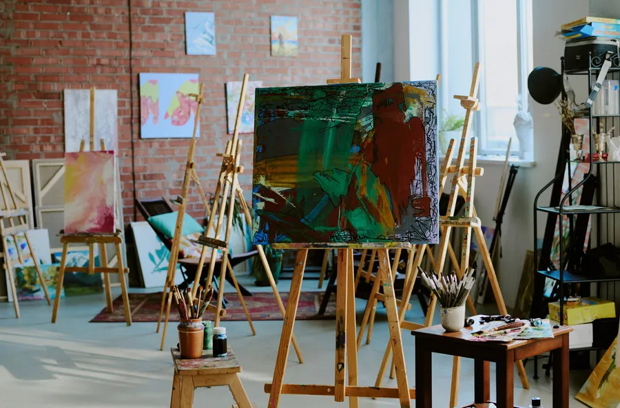 Bright art studio with easels and paintings