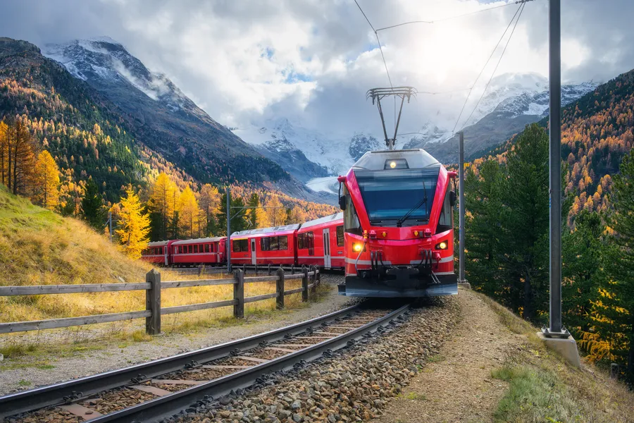 Mountain train crossing an autumn alpine landscape