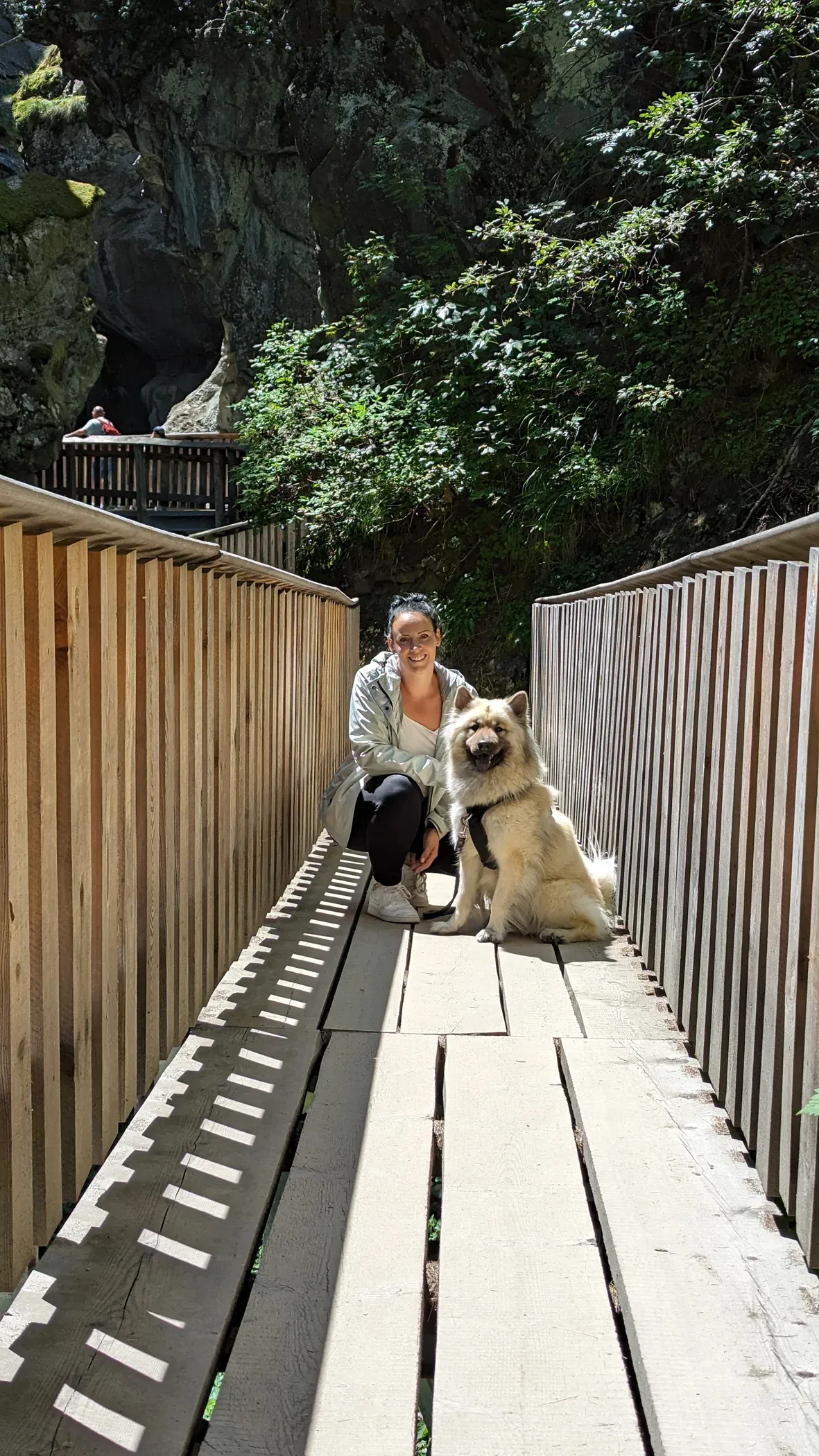 Sandra Walenta and her dog on a wooden bridge in a rocky gorge