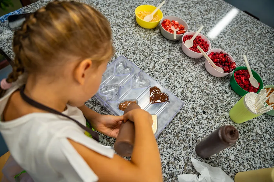 Child shaping chocolate in a hands-on workshop