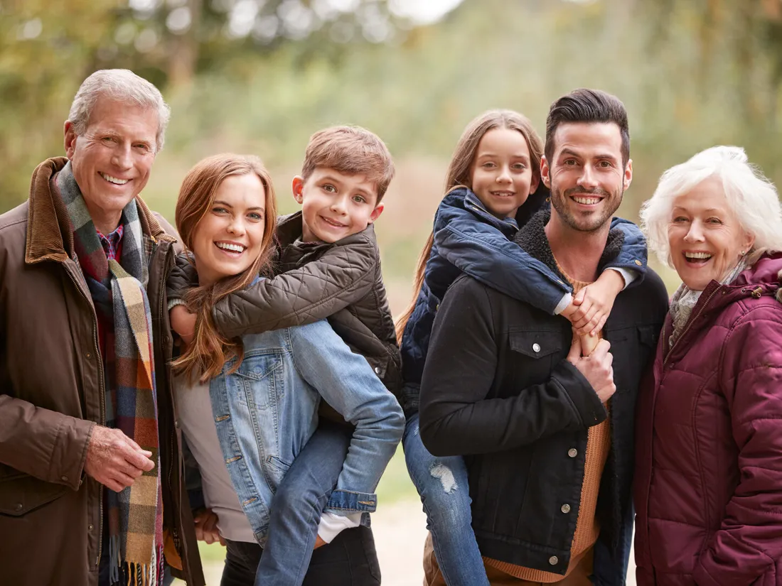 Three generations smiling together in nature