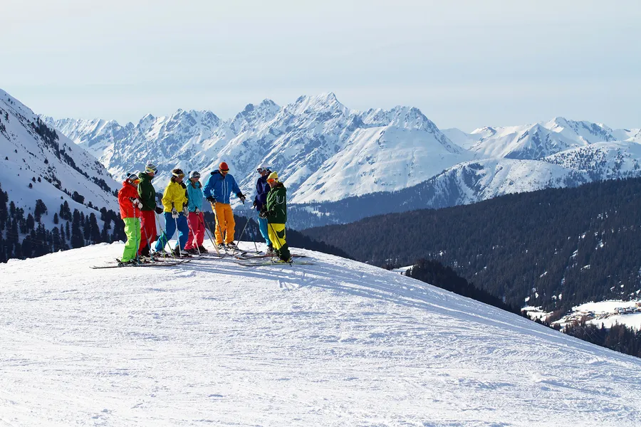 Group of skiers above snow-covered mountains in Kuhtai, Tyrol