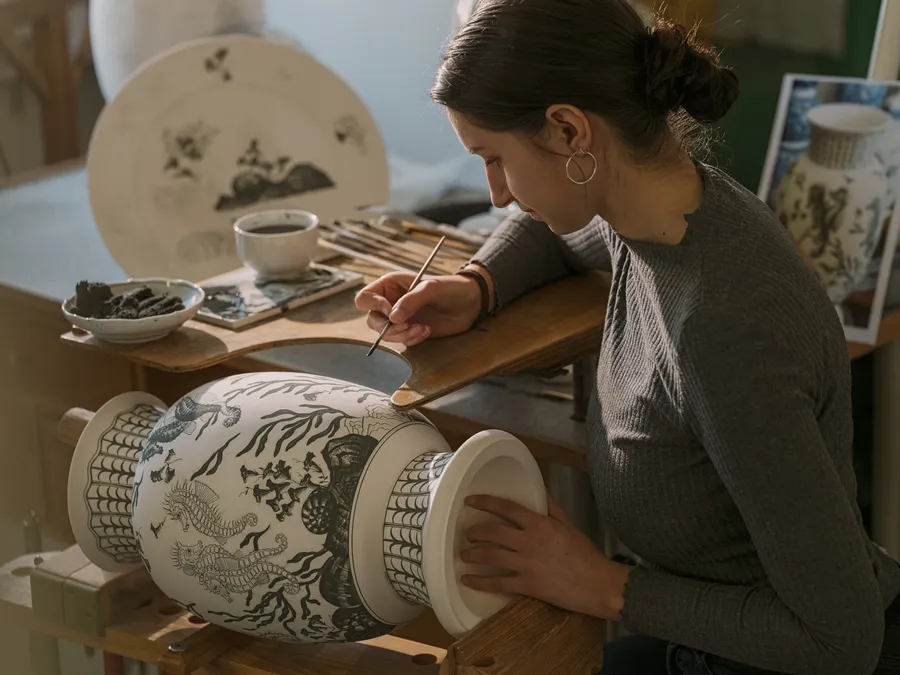 Artisan hand-painting a porcelain vase at the MEISSEN manufactory
