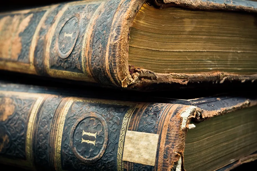 Antique leather-bound books with aged pages
