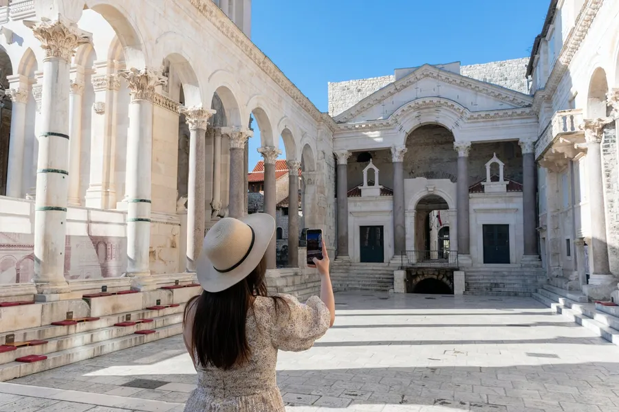 Traveler photographing the Peristyle of Diocletian’s Palace in Split